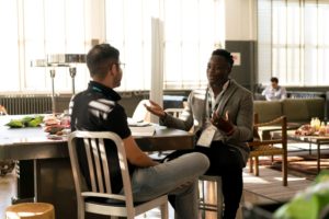 Two men talking at the office.