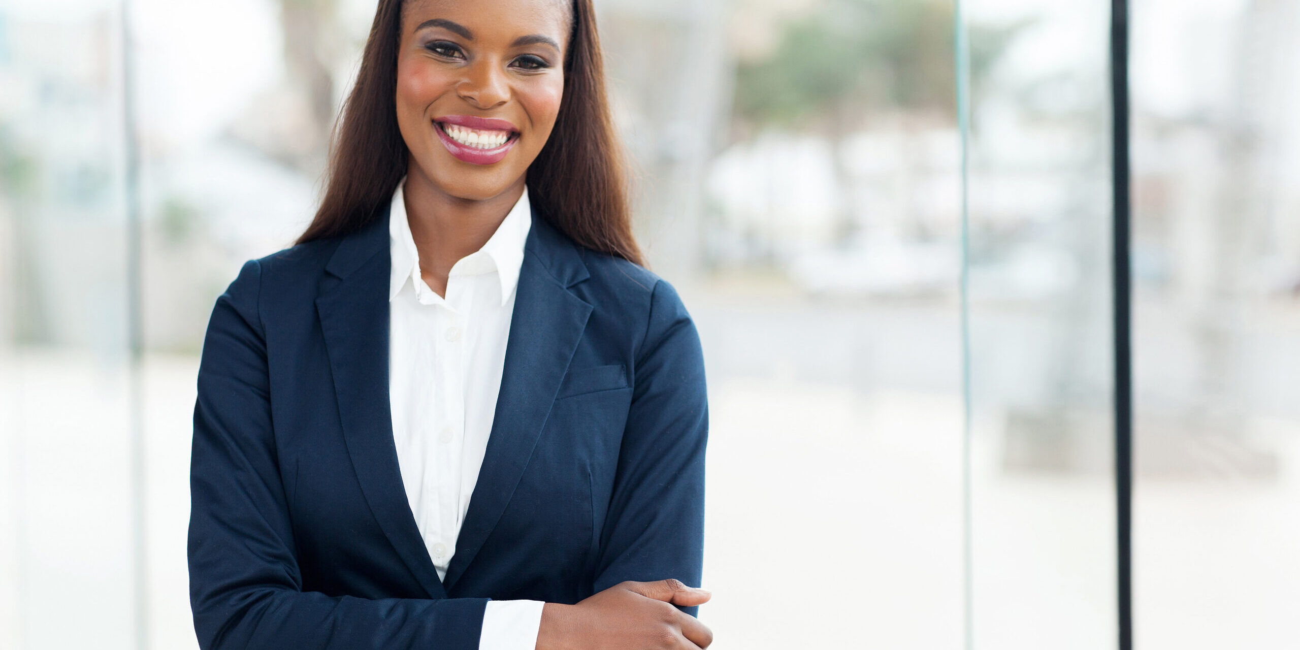 A smiling woman in a suit.