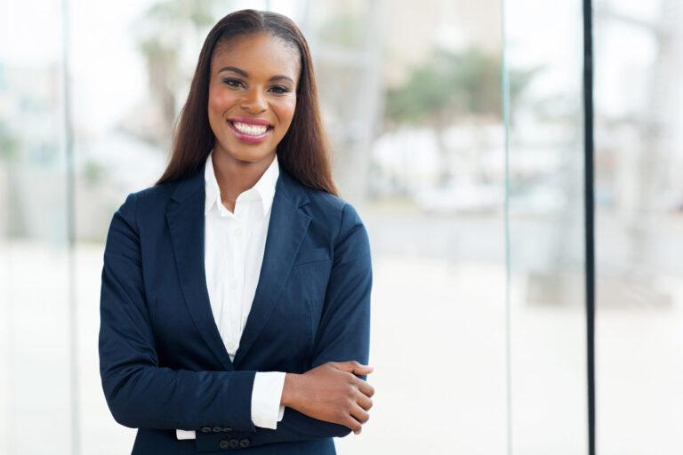 A smiling woman in a suit.