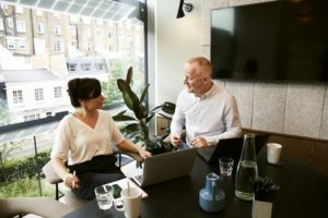 Two people having a discussion in an office.