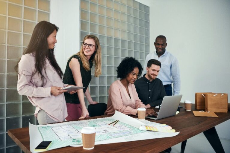 A group of co-workers working happily together.