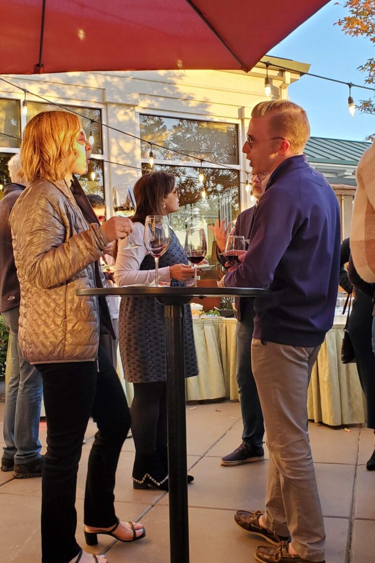 Seminar attendees enjoying wine at the reception.