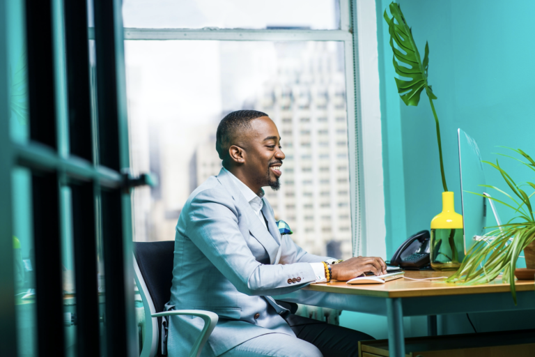 A man working happily on his computer.