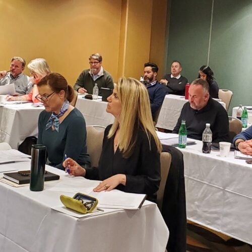 Seminar attendees listening attentively during a seminar.