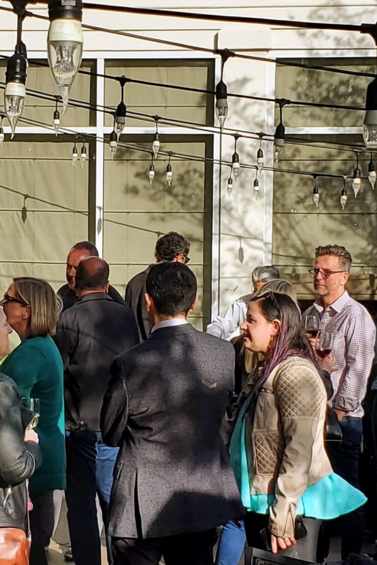 Seminar attendees talking and eating at the reception.