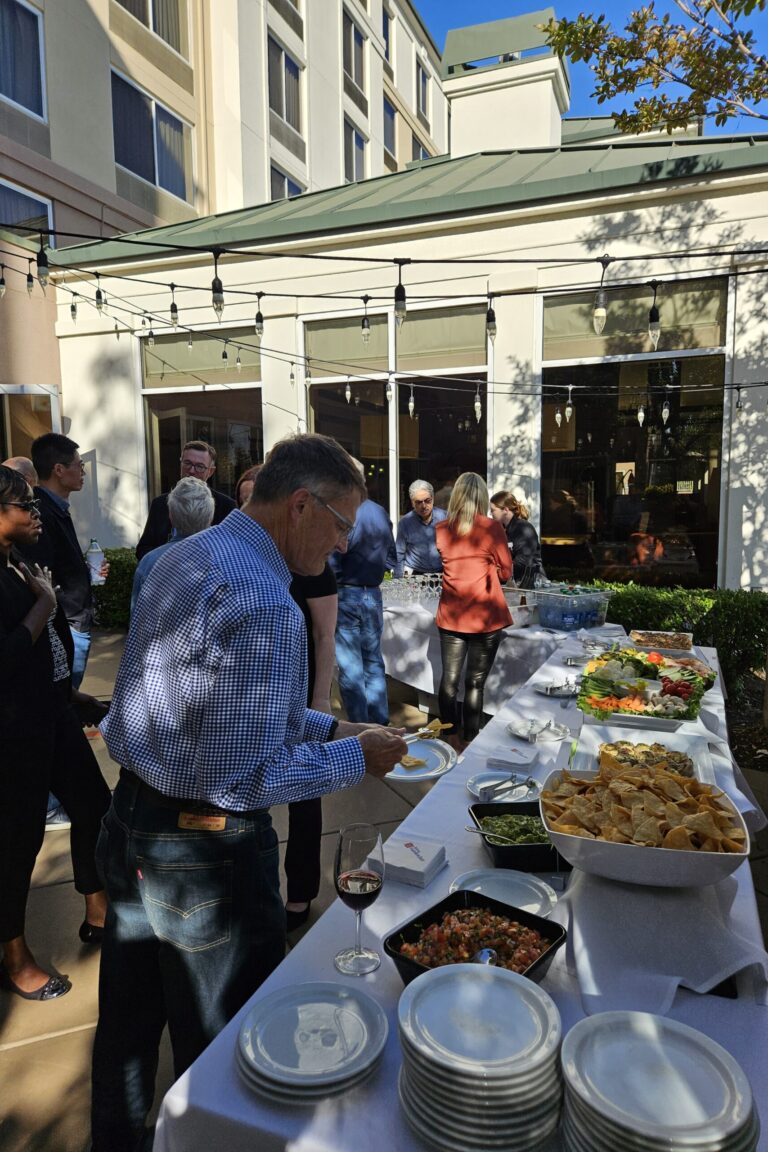 A seminar attendee adding food to his plate.