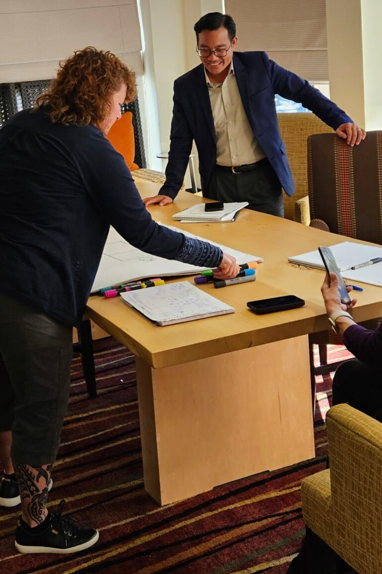 Seminar attendees gathering to work on an activity together.