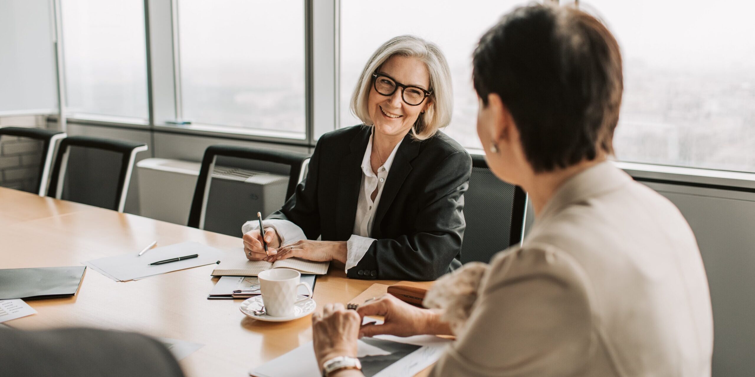One woman coaching another in an office setting.