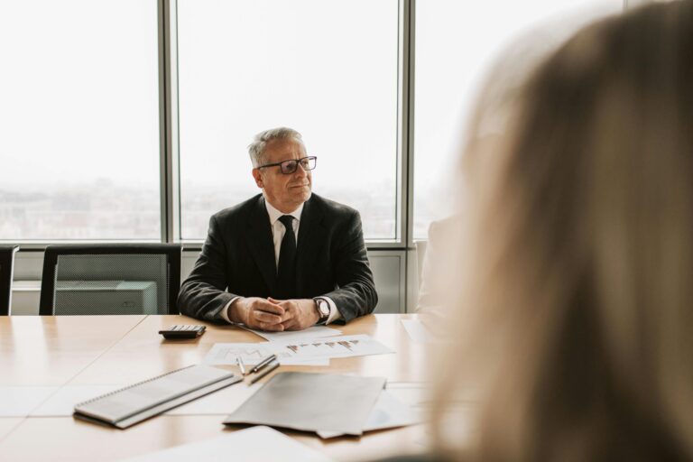 A business man sitting at a table being coached.