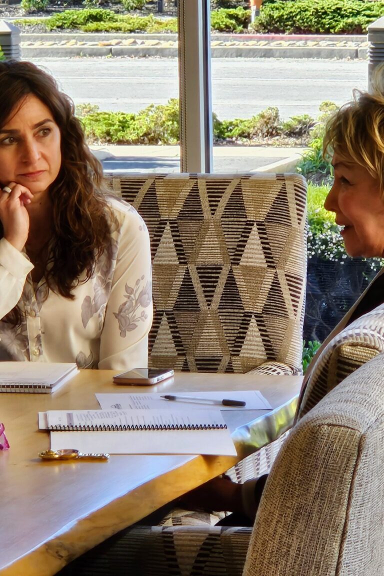 One seminar attendee listens attentively as another speaks.