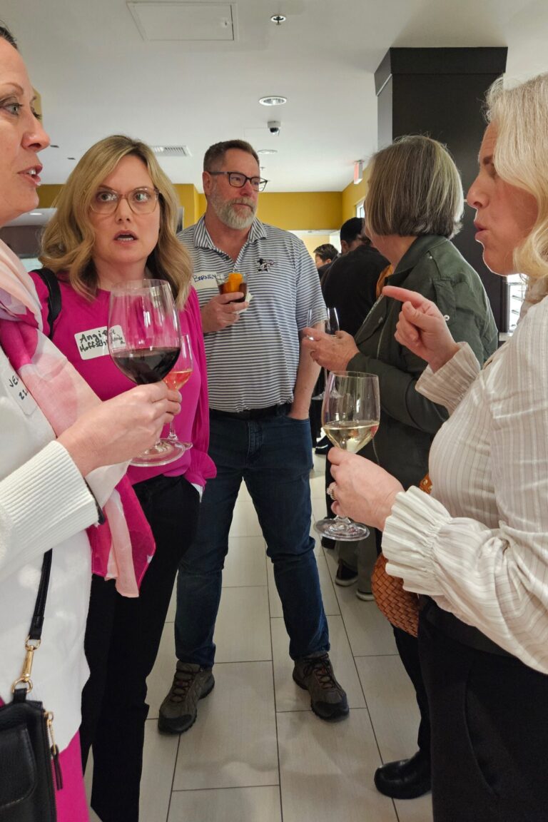 A group of seminar attendees having a discussion at the reception.