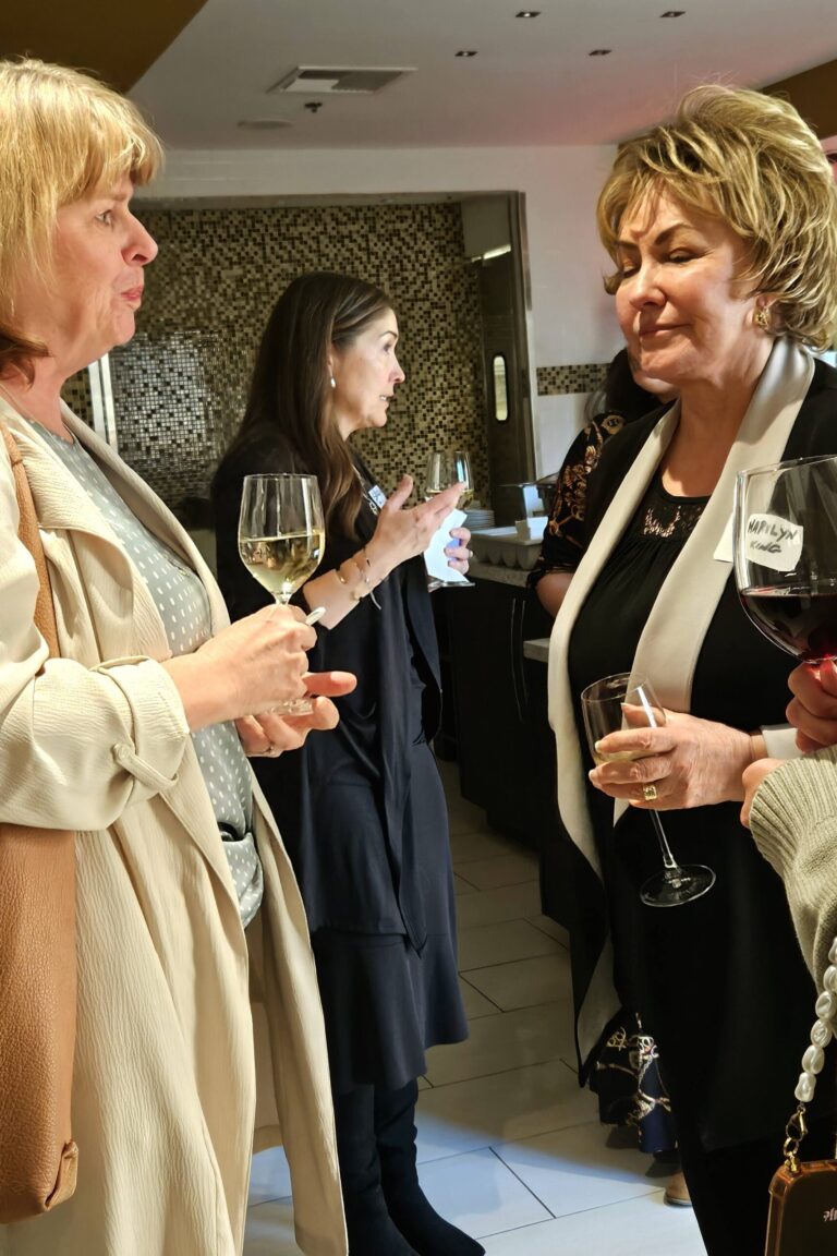 Seminar attendees enjoying wine together during the reception.