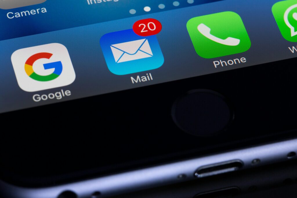 Photo of a phone mail app with a red dot on the top right corner notifying of 20 unread emails.