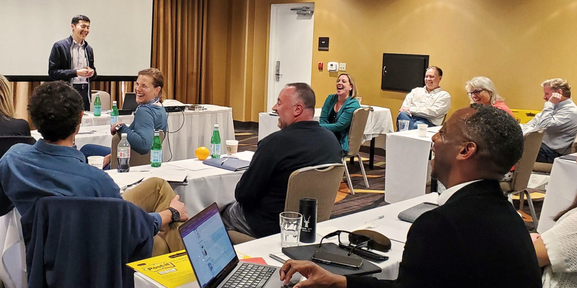 Michael Neuendorff presenting in front of a group of coaches.