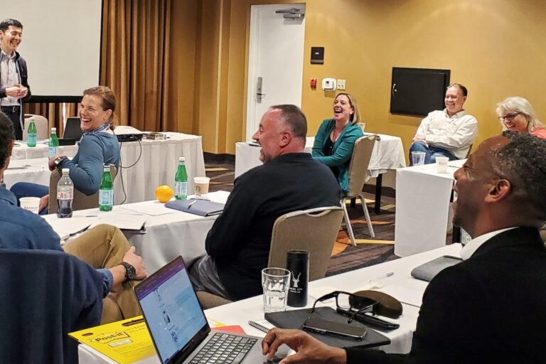 Michael Neuendorff presenting in front of a group of coaches.