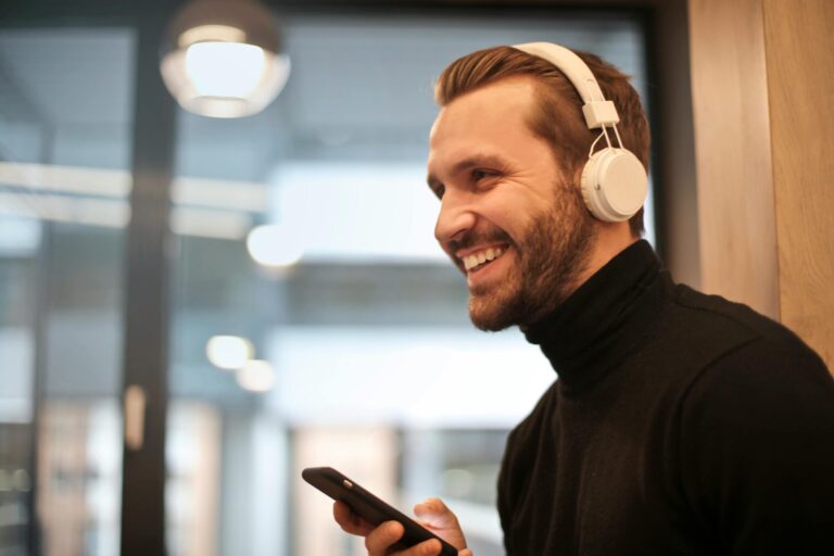 Man wearing white headphones listening to audio coaching.