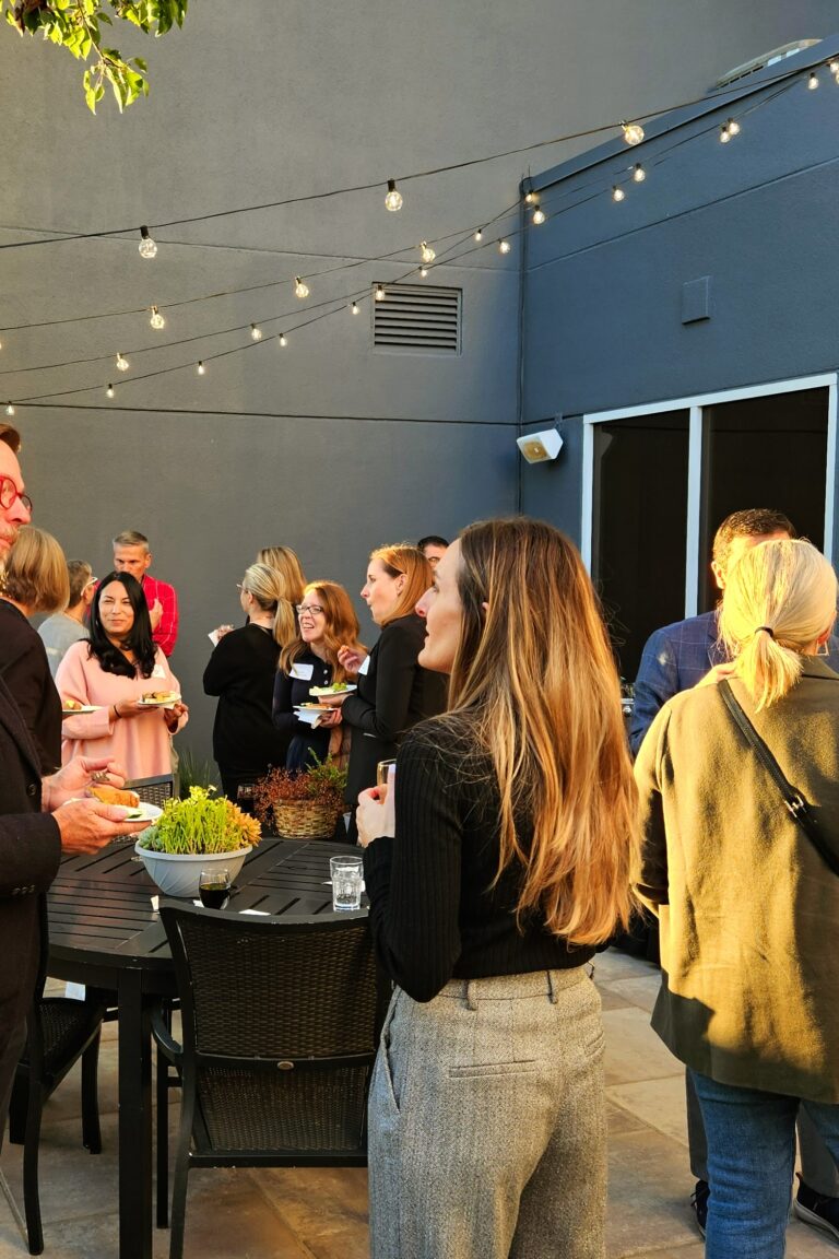 Seminar attendees and instructors milling about during an afterparty.