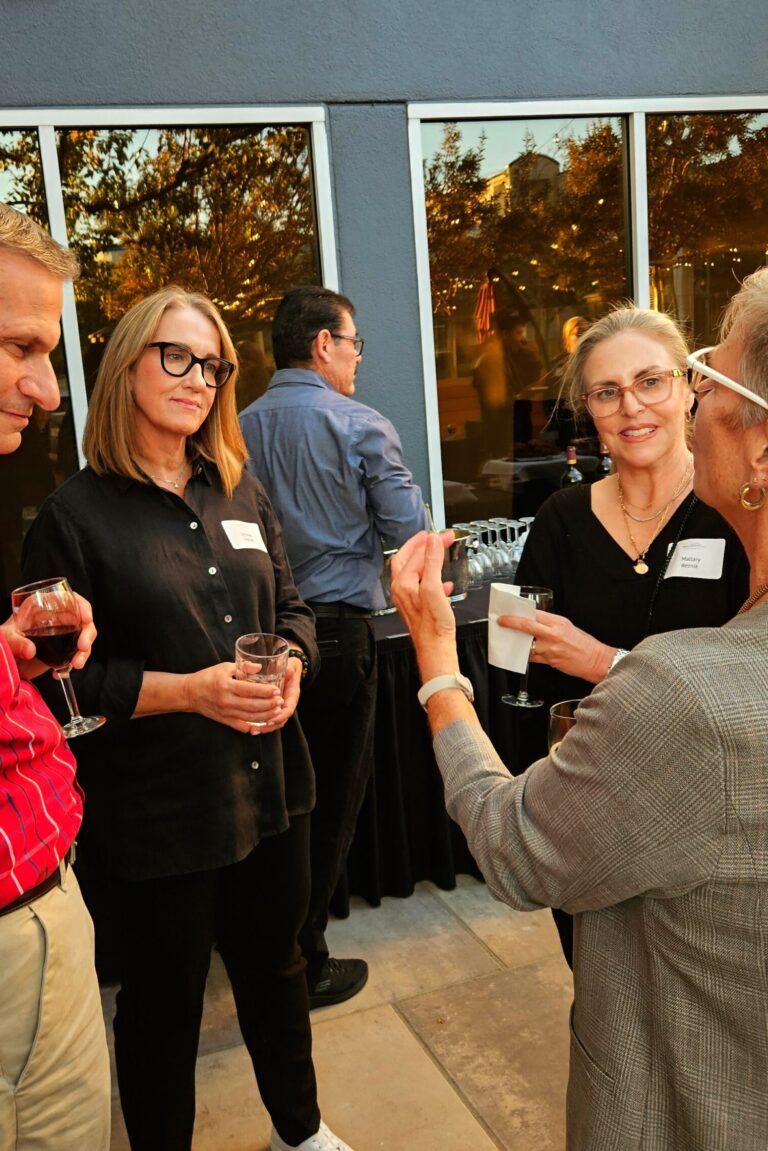 A group of seminar attendees listening intently as one speaks.