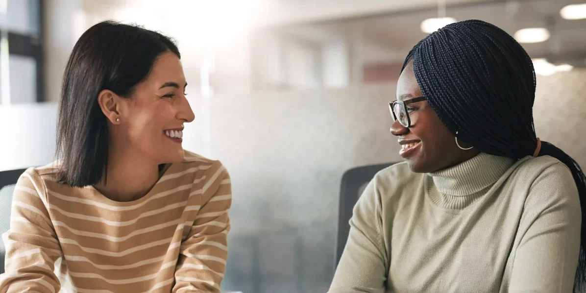 A photo of two women having a conversation