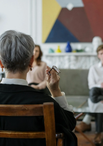 A therapy session with a women and two people.