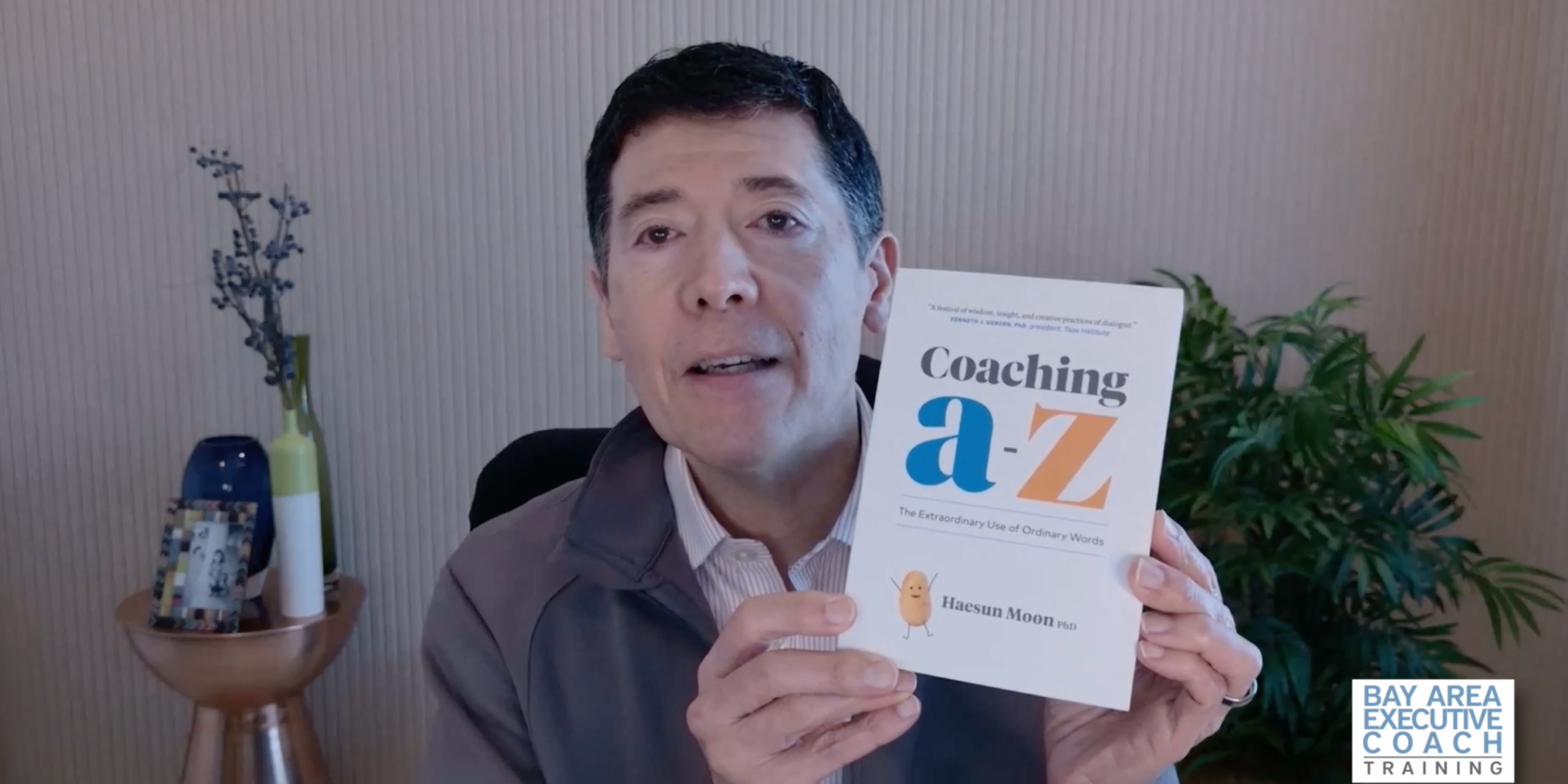 Michael Neuendorff holding up the book Coaching a-z by Haesun Moon
